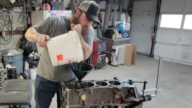 Man filling engine block with Hard Blok filler