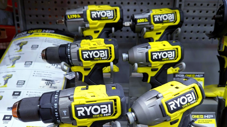 Ryobi power drills and drivers sitting together on a shelf