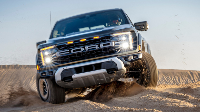 2024 Ford Raptor driving in the sand