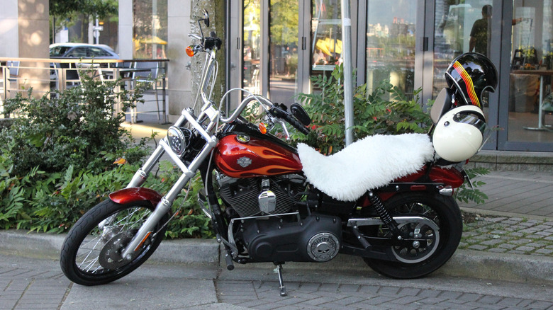 A classic Harley Davidson motorcycle with sheepskin on the seat