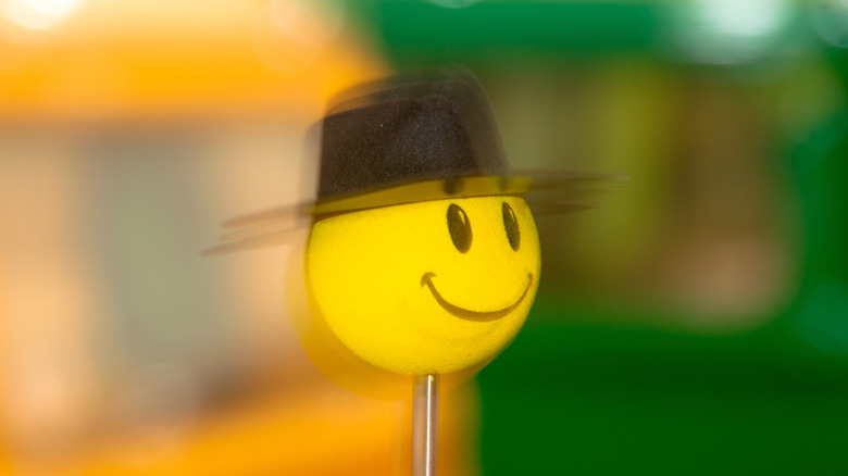 Smiling tennis ball with hat on top of antenna