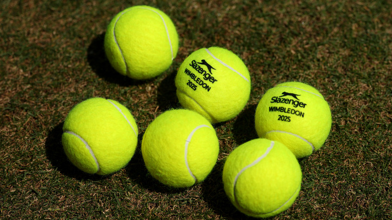 Six tennis balls on grass