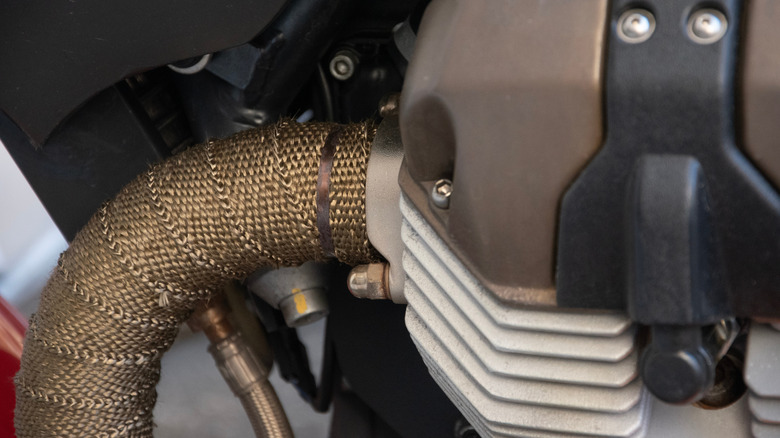 Close-up details of a wrapped exhaust pipe on a motorcycle