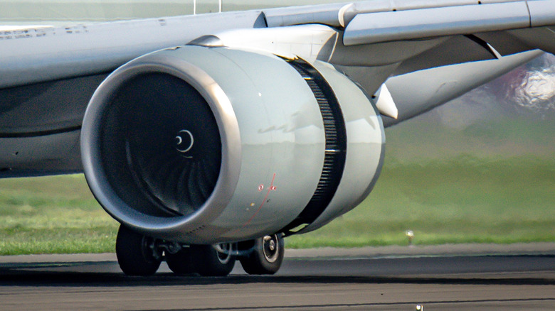 Close-up of left-side engine cascade-type reverser deployed during landing, front-left view