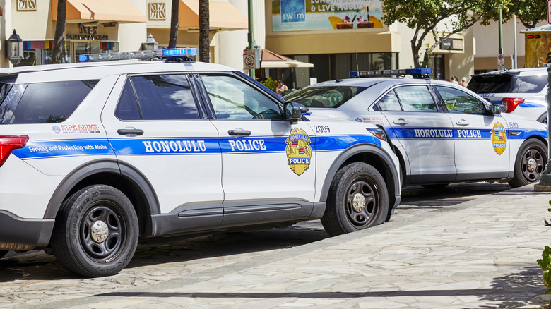 Several Honolulu Police Vehicles Parked Along The Street