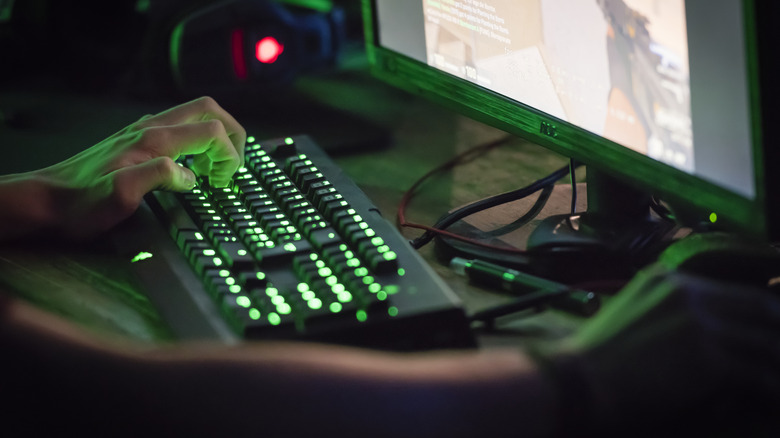 A tilted keyboard is seen as a PC player plays Valorant