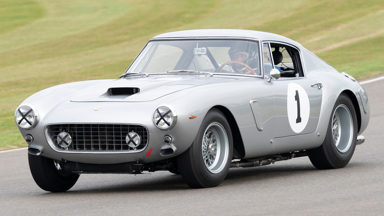 A sports car with taped headlights on a track