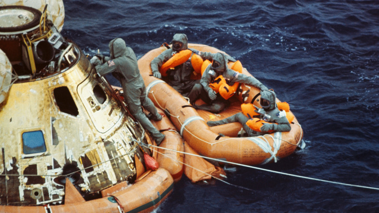 Rescue swimmer closes the hatch of Apollo 11