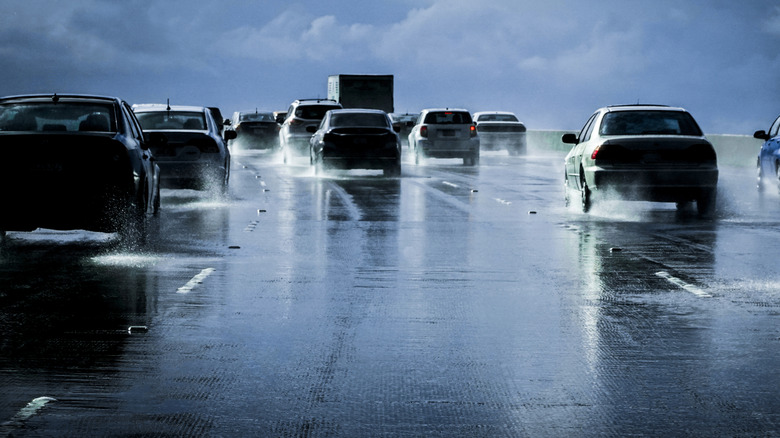 Vehicles in traffic on wet highway in rain
