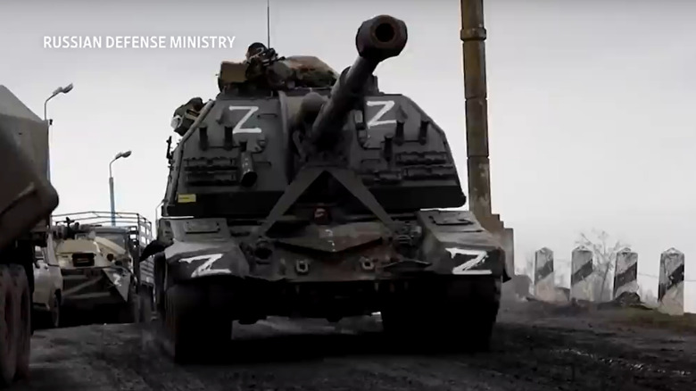 A Russian tanks painted with white z symbols forge ahead in formation
