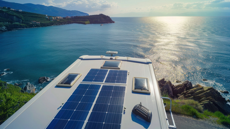 An RV Roof With Skylights And Solar Panels Near The Shoreline