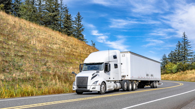 Semi truck going down a winding road