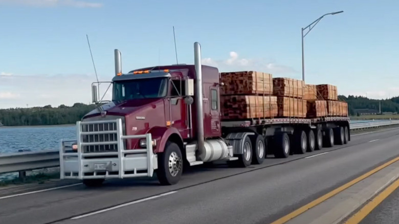 Loaded semi truck in Michigan driving near water with 10 axles