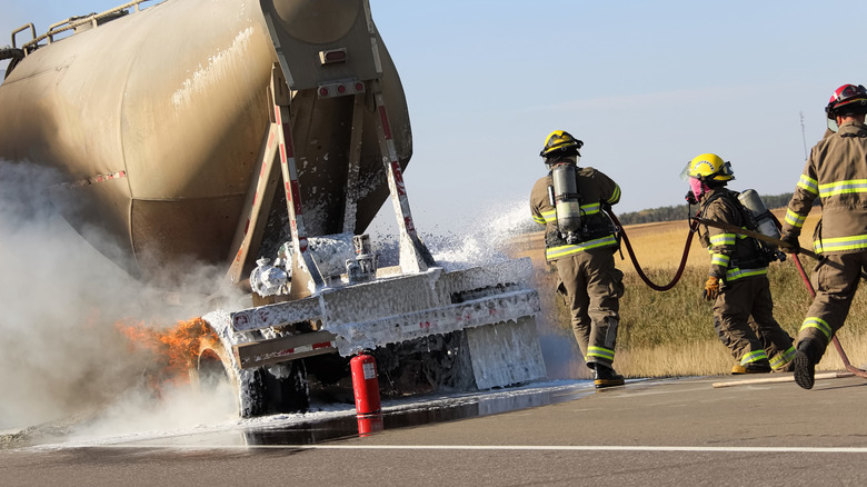 Fire fighters putting out 18-wheeler brake fire