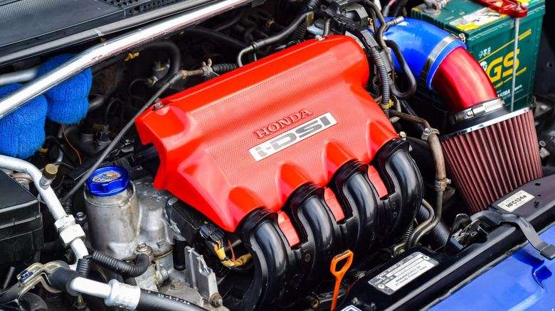 Car with hood open revealing a Honda i-DSI engine