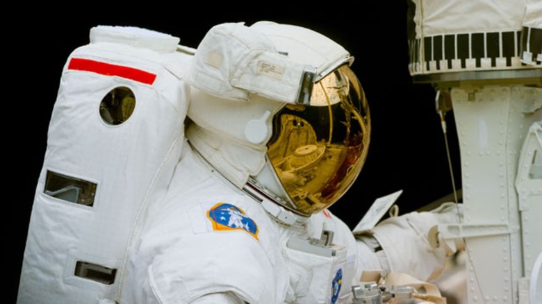An astronaut on an EVA working on the Hubble Space Telescope
