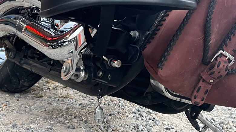 A silver Guardian Bell handing at the bottom of a bike