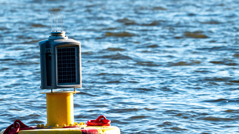 Buoy with solar panel in ocean.