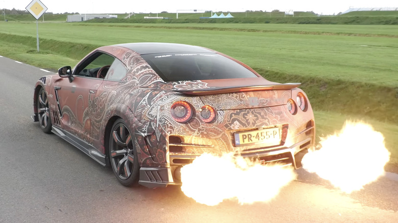 A modified Nissan GTR backfires from the exhaust