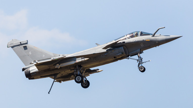 A fighter jet with its tail hook down