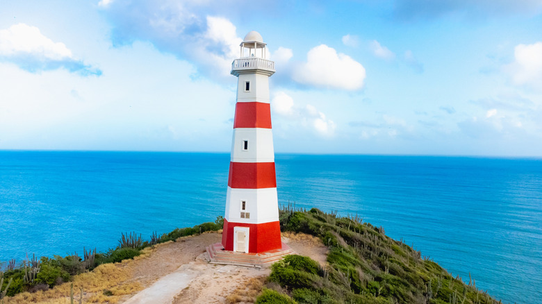 Small lighthouse overlooking blue ocean