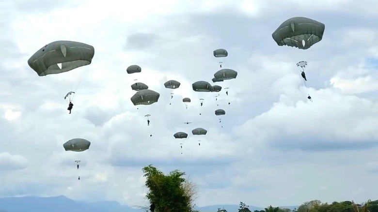 A group of soldiers using T-11 parachutes dropping into a location