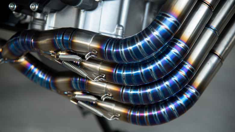 Part of a motorcycle exhaust pipe system turning blue due to oxidation