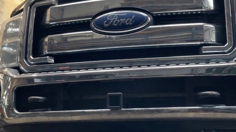 A Ford truck with a trailer hitch attached to the front.