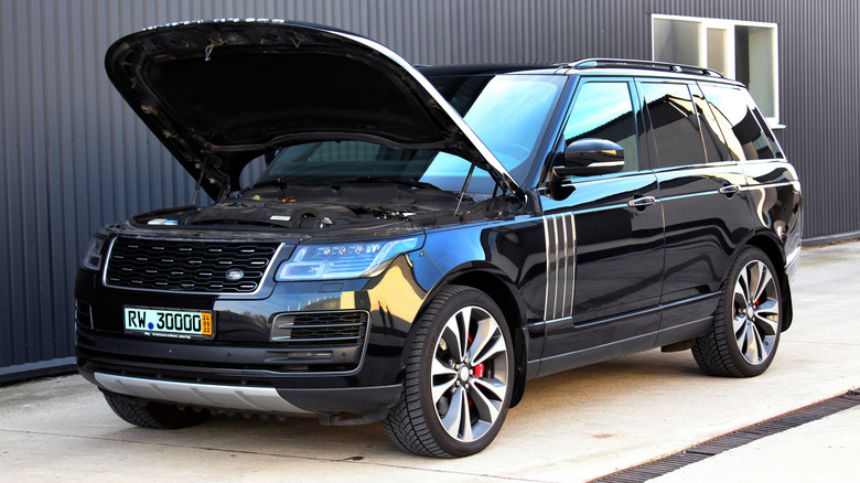 Black Range Rover parked with its hood open
