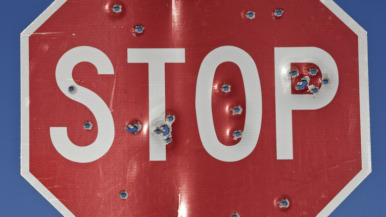 Stop sign with several holes through it