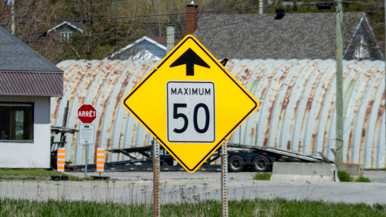 Warning road sign for an approaching 50 mph speed limit zone