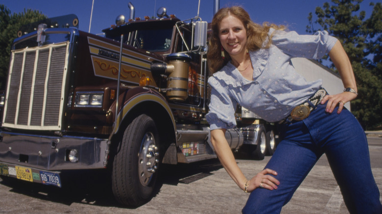 Long-distance trucker Gale Russell stands next to a semi-truck with multiple license plates on Feb. 20, 1987 in Riverside, California.