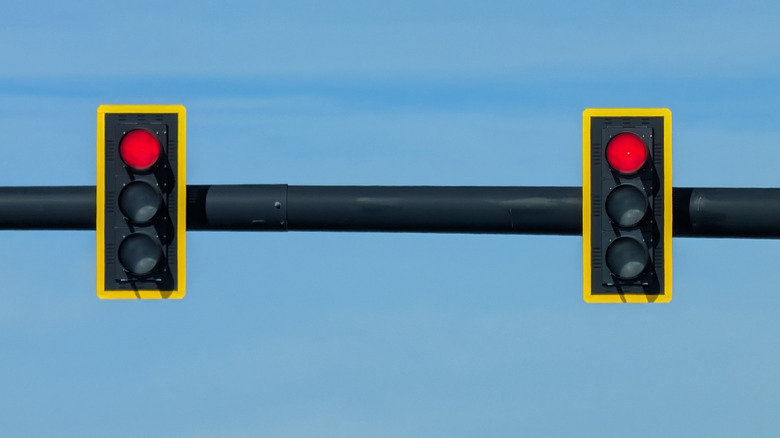 Two traffic lights with a yellow border