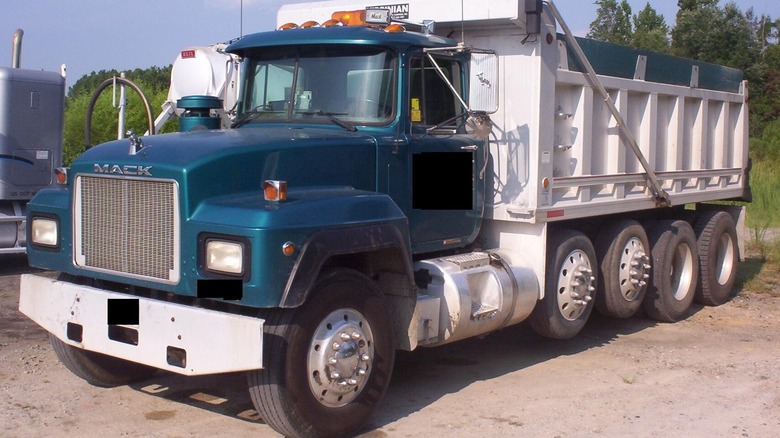 A truck with some of its tires off the ground