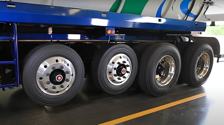 A truck with raised lift axles on a pavement