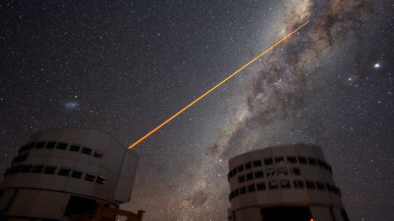 A single laser beam shoots from a Very Large Telescope dome toward the center of the Milky Way