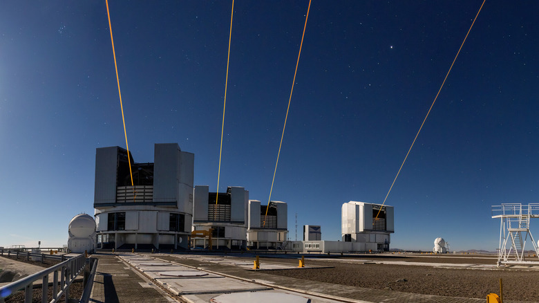 All four big telescopes at ESO's Very Large Telescope fire laser beams into a moonlit sky over Chile's Paranal Observatory