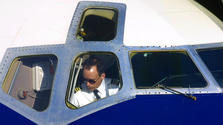 pilot seen through cockpit windows