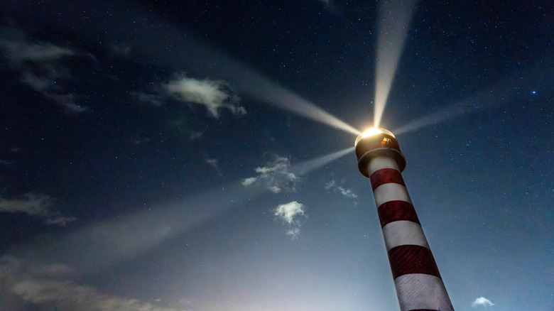 Lights in a lighthouse rotating at night