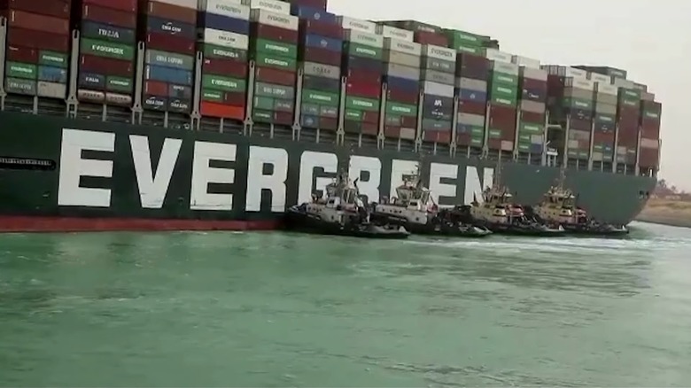 Several Tugboats Pushing The Ever Given Which Became Stuck In The Suez Canal