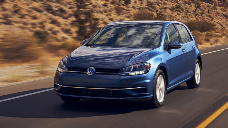 a blue 2021 volkswagen golf on the highway