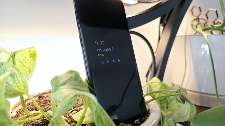Samsung Galaxy S9+ showing a clock and weather forecast