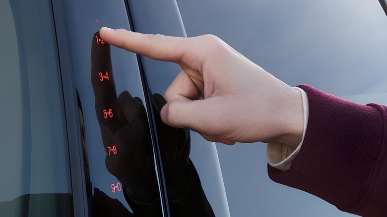 Man's finger pressing Ford capacitive touch keypad