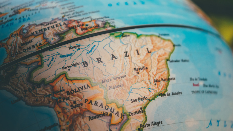 A globe highlighting the equator over Brazil