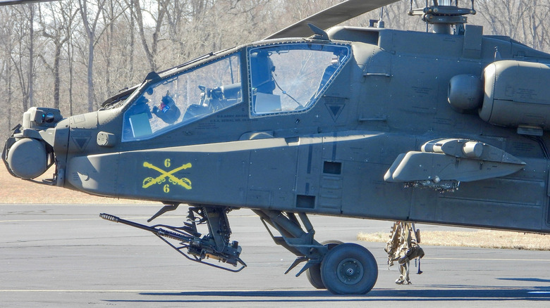 Side view of grounded Apache helicopter