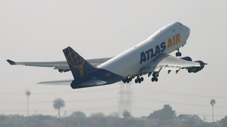 An Atlas Air Boeing 747 takes off from a Los Angeles airport runway.