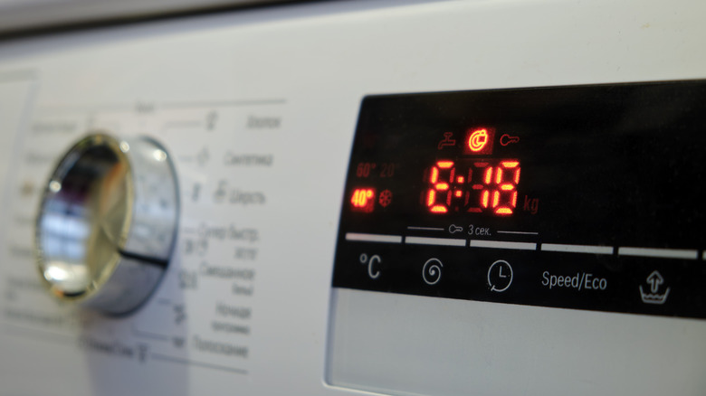 Close-up of a washing machine control panel with a digital display and a error code E18