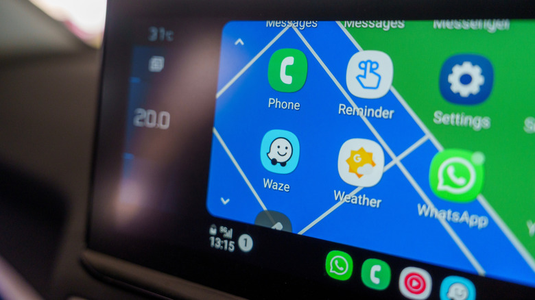 The Android Auto interface showing Waze and WhatsApp among other apps on a car's head unit