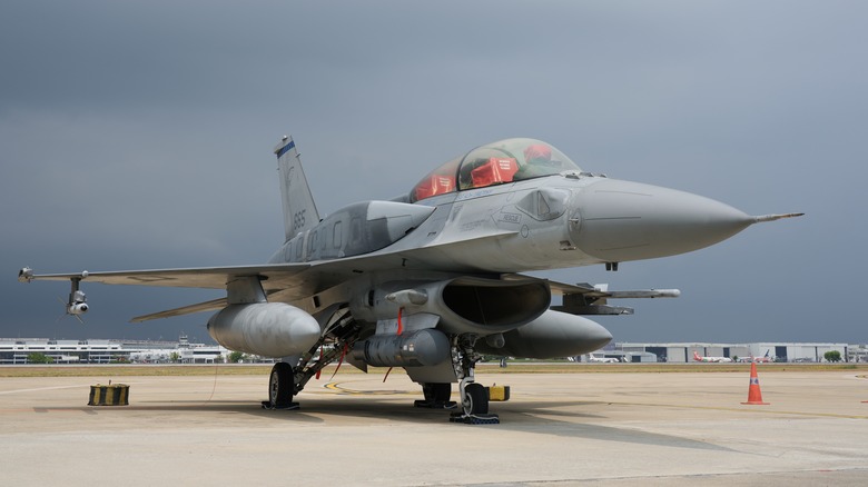 A close-up of an F-16 Block 70 fighter jet at Don Muang airport on a cloudy day