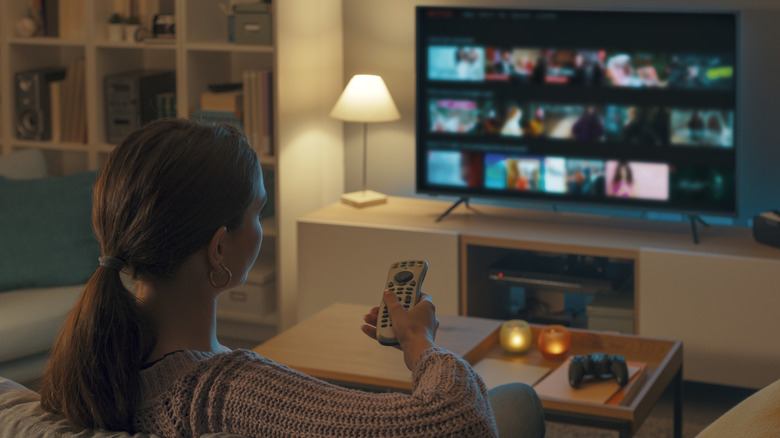 A woman watches TV